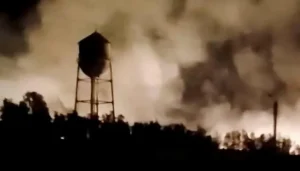 Smoke rises near a water tower after fresh US airstrikes during the US Iran War in Iran.