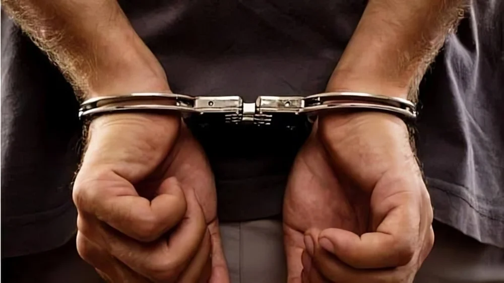 Suspect in handcuffs after Vehari Theft Gang bust involving motorcycle theft and burglary cases