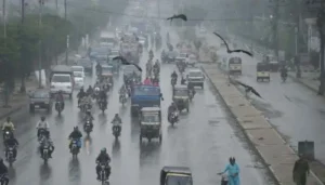 Vehicles move through heavy rainfall in Karachi as Weather Forecasting and early warning systems are strengthened in Pakistan.
