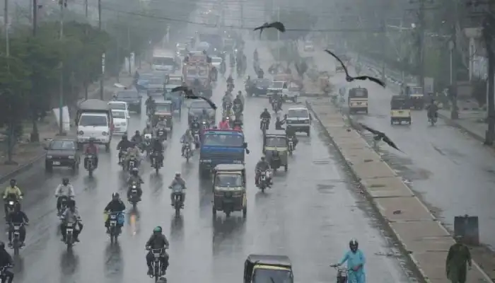 Vehicles move through heavy rainfall in Karachi as Weather Forecasting and early warning systems are strengthened in Pakistan.