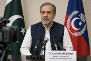 Dr Abdul Malik Baloch speaking at press conference calling for Balochistan political solution with Pakistani and Balochistan flags in background