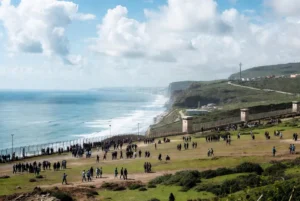 Crowds of people gathering near the border fence during Ceuta migrant crisis overlooking the Mediterranean coast