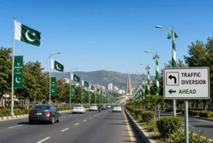 Islamabad avenue with Pakistani flags, traffic diversion sign and vehicles during Islamabad traffic plan for Independence Day celebrations