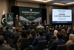 Speakers and attendees at Kashmir conference in Dallas Texas discussing peaceful settlement of Kashmir issue under UN resolutions with Pakistani flags and banners