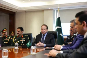 Nawaz Sharif seated with military and political leaders in formal meeting promoting institutional unity with Pakistani flags in background