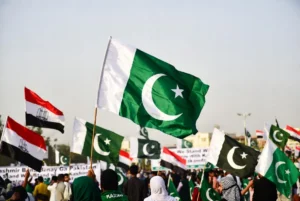 People waving Pakistani and Kashmir flags during a peaceful solidarity gathering on Youm-e-Istehsal Kashmir in support of self-determination