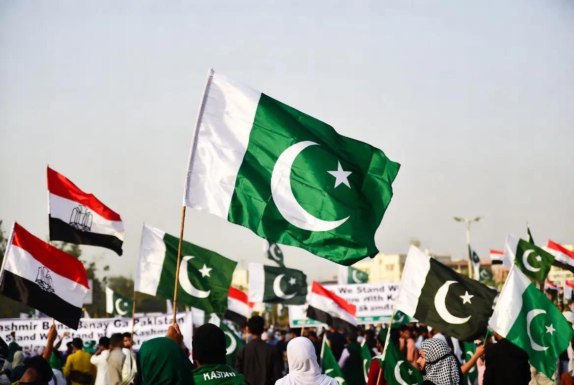 People waving Pakistani and Kashmir flags during a peaceful solidarity gathering on Youm-e-Istehsal Kashmir in support of self-determination