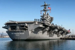 USS Abraham Lincoln Nimitz-class aircraft carrier docked at port under clear sky linked to carrier suicide attempts report