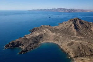 Aerial view of the strategic Houthi Perim island in the Bab el-Mandeb Strait with Red Sea shipping lanes and Yemeni coastline
