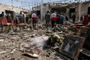 Aftermath of Iran wedding strike in Sirik with damaged wedding venue and rescue workers