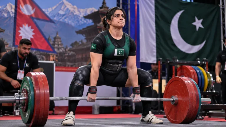 Pakistani female powerlifter performing a deadlift at a championship in Nepal, representing Ayesha Hassan Gold medal victory.