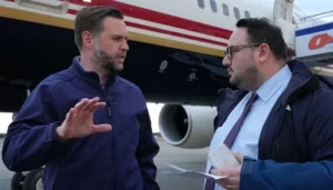 US Vice President JD Vance speaking with a Reuters journalist near an aircraft during discussions over Iran enrichment