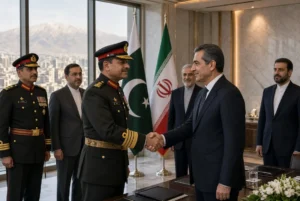 Field Marshal Asim Munir in military uniform shaking hands with Iranian official during Munir Tehran Visit in formal Tehran meeting hall with Pakistan and Iran flags