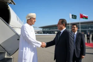 Oman FM Pakistan - Omani Foreign Minister Sayyid Badr Albusaidi in traditional attire shaking hands with a Pakistani official at Islamabad airport during official visit for Joint Ministerial Commission talks