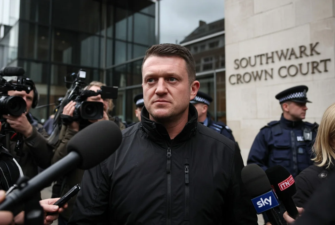 Tommy Robinson standing outside Southwark Crown Court surrounded by media after being convicted of harassing two journalists
