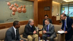 UN Secretary-General Antonio Guterres sitting and discussing with official delegates inside an airport VIP lounge